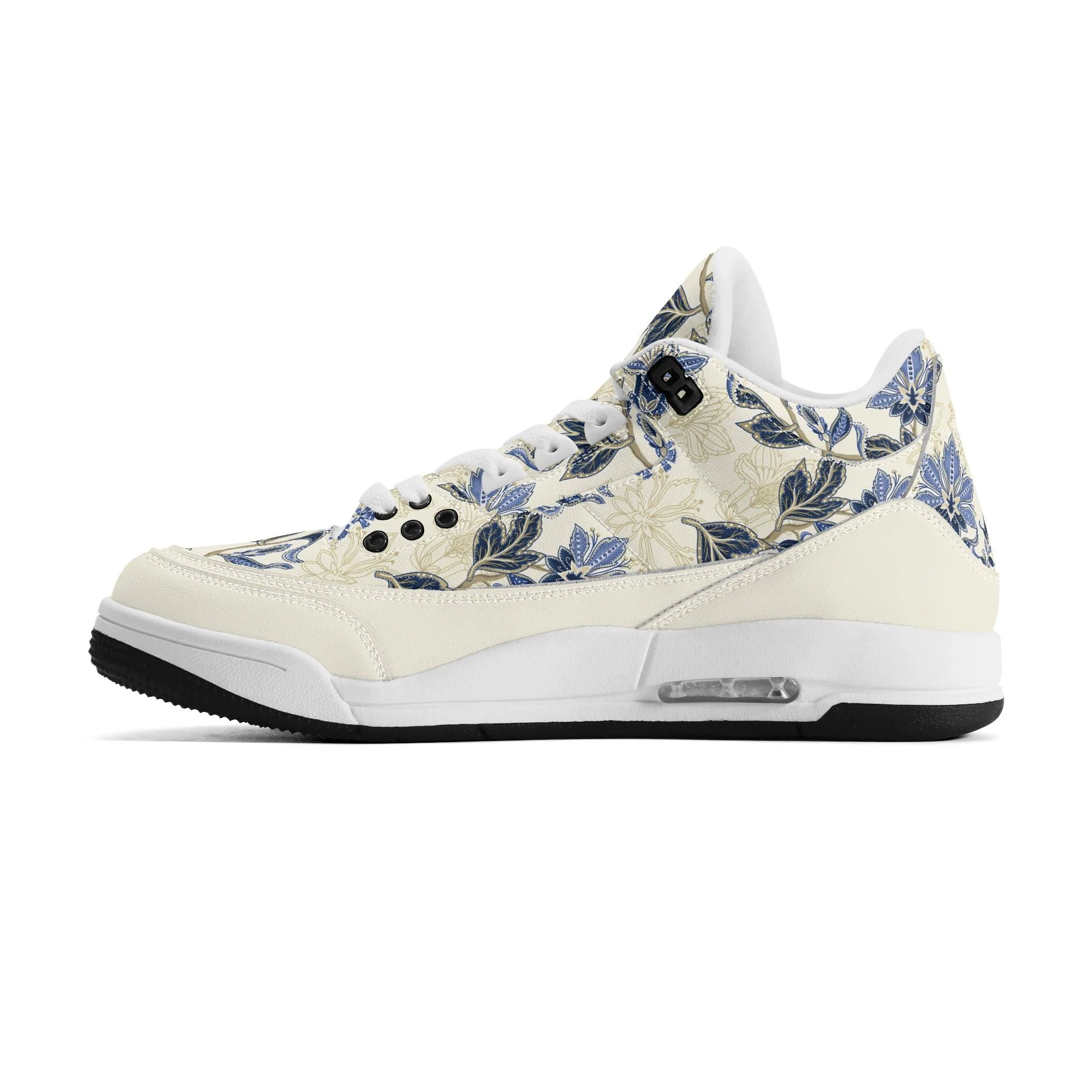 Zapatillas retro de baloncesto en color crudo con estampado floral vintage en azul y dorado, mostrando tobillo alto acolchado y suela antideslizante.