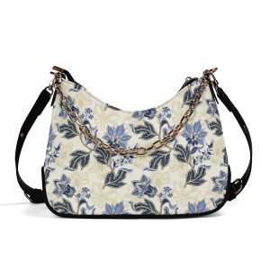Bolso bandolera floral vintage en piel PU, mostrando estampado azul/dorado, cadena ajustable y cierre de cremallera seguro.