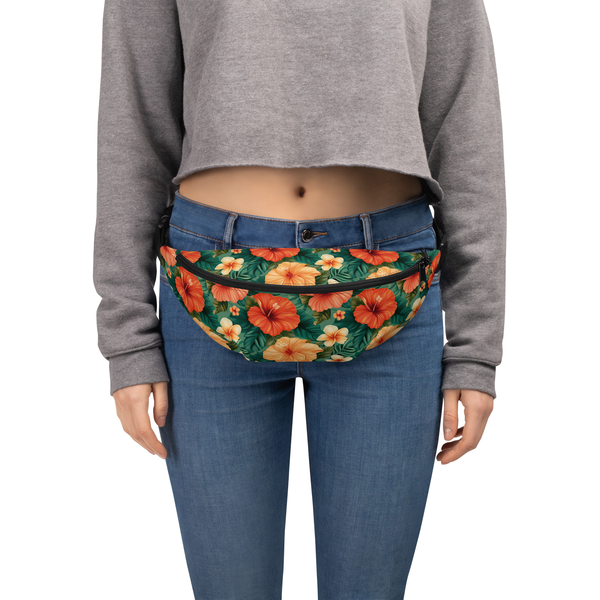 Riñonera tropical con estampado de hibiscos sobre fondo verde intenso. Vista frontal con diseño vívido y funcionalidad urbana.